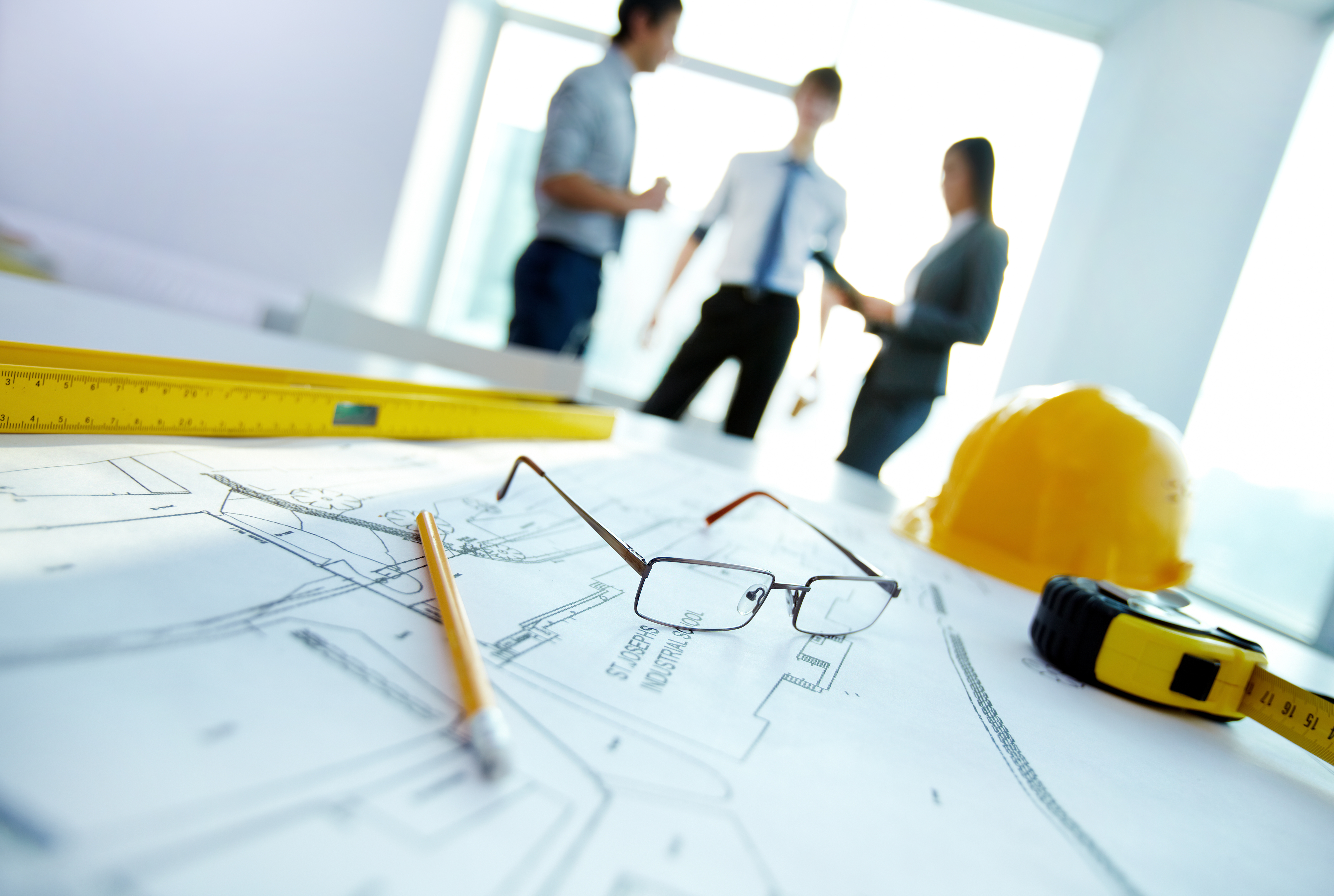 graphicstock-engineering-objects-on-workplace-on-background-of-talking-co-workers_S8qTNt5Q-