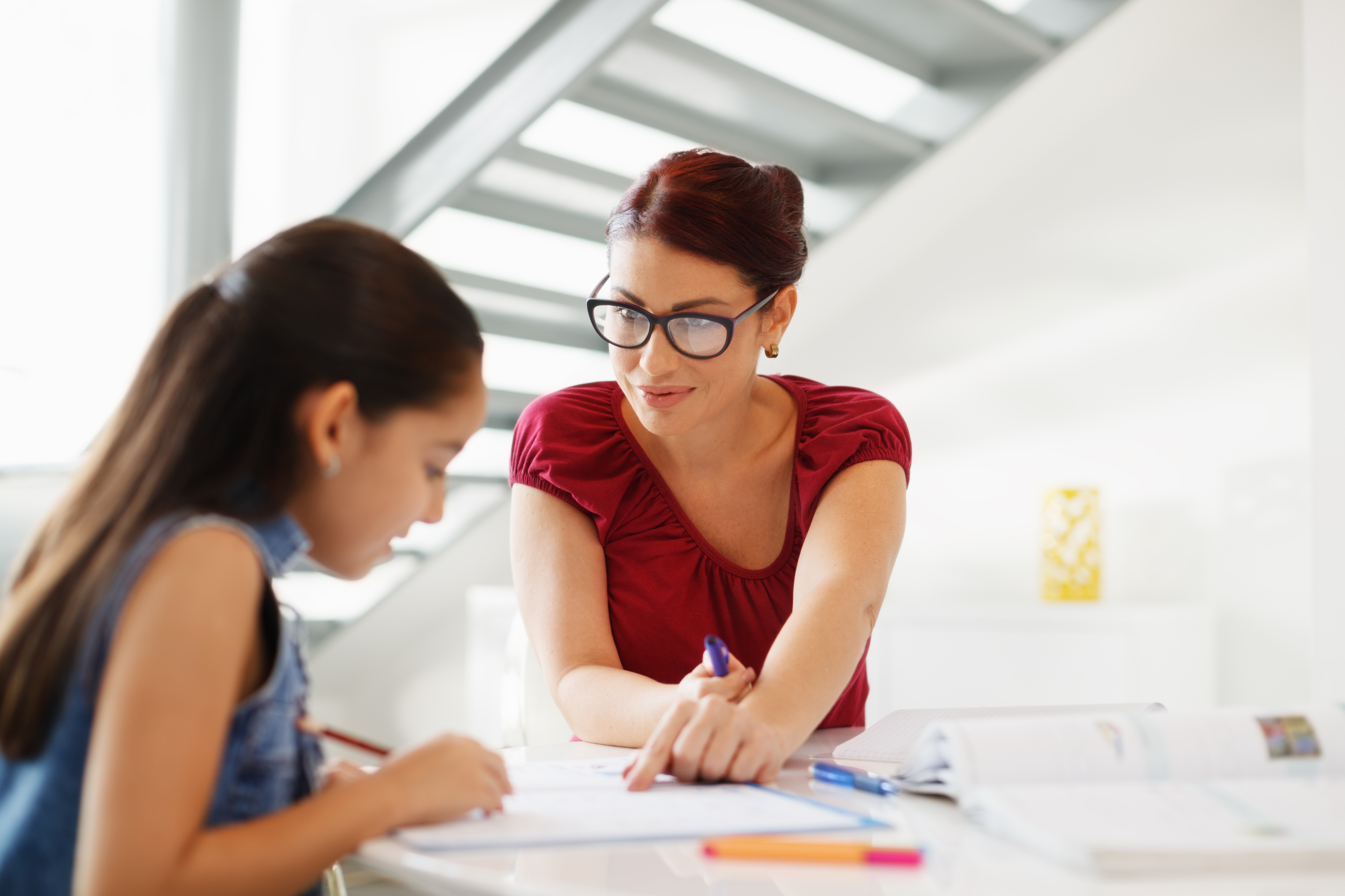 Storyblocks hispanic mother and female child with mom helping daughter with school homework SnzYr2qLSG