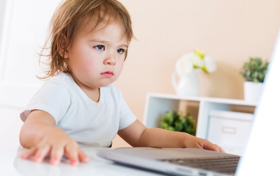 Young child procrastinating with her school work online school difficult
